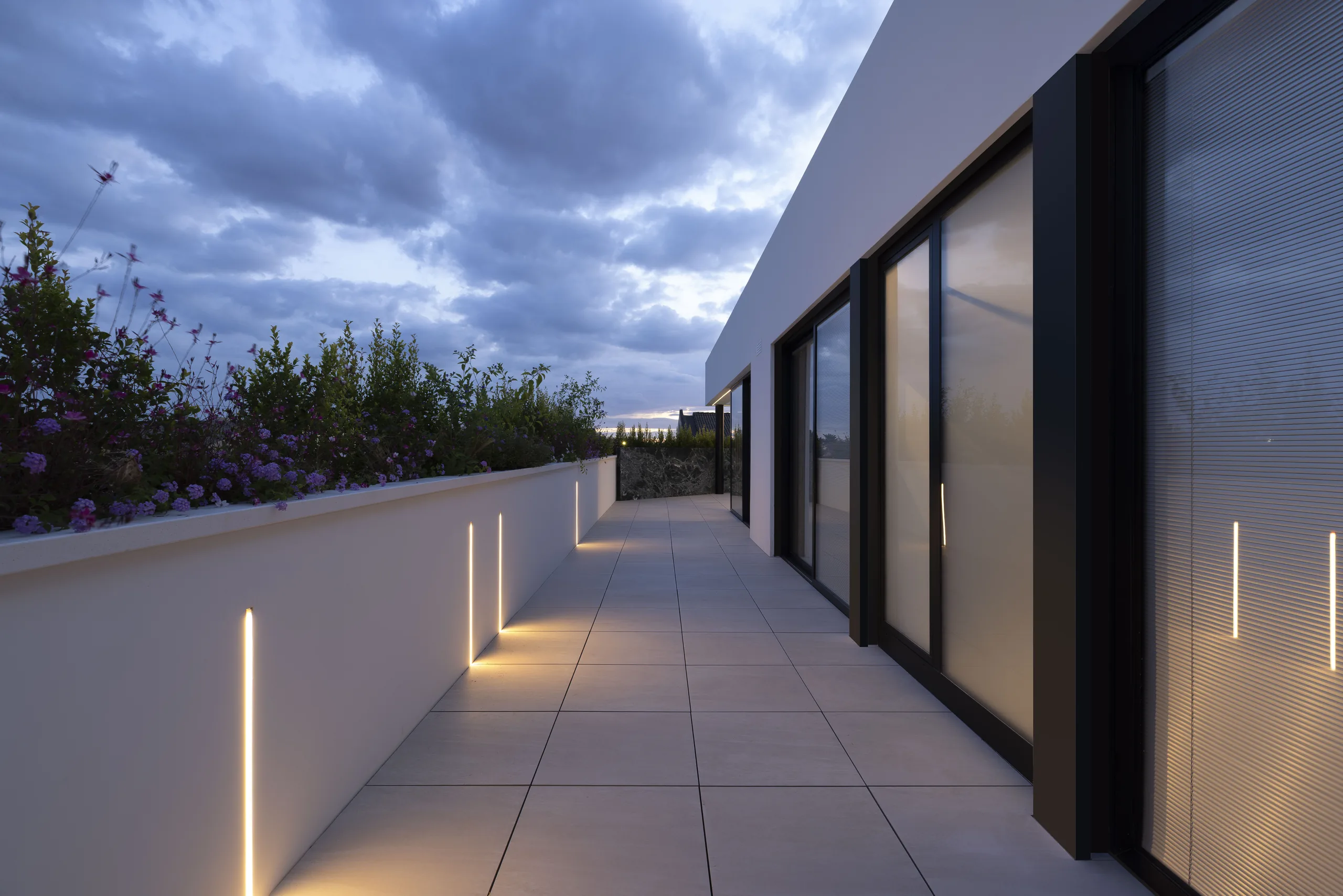 glazed living area in a Selargius penthouse opening onto the terrace