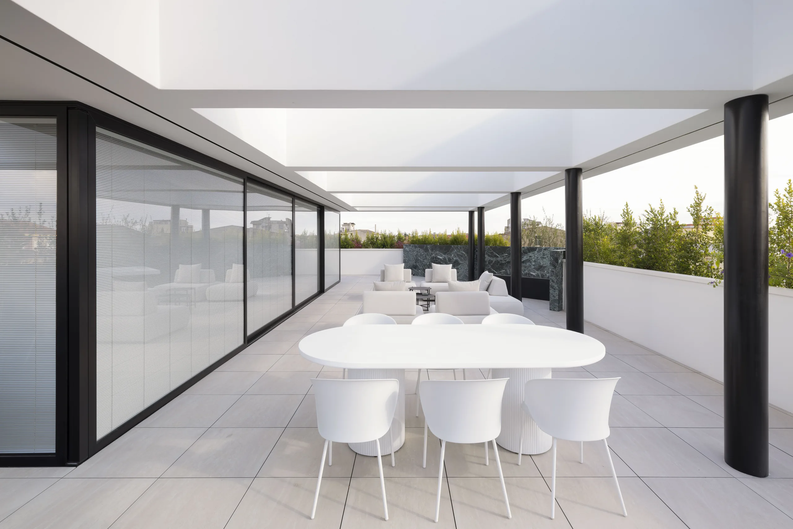 white pergola on a Selargius penthouse terrace framing the sky